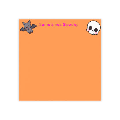 Orange notepad with a bat and skull design and text 'Sometimes Spooky' on a white background