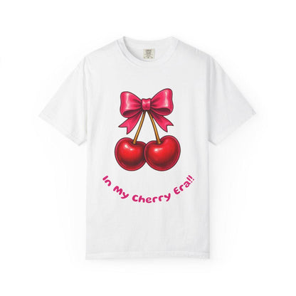 White t-shirt with red cherries and a pink bow graphic on a white background