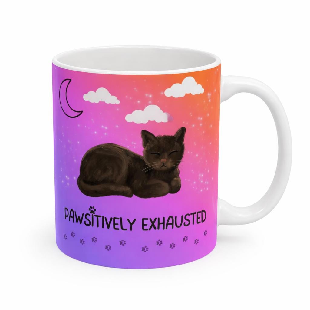 Mug with a cat illustration and 'Pawsitively Exhausted' text on a colorful gradient background