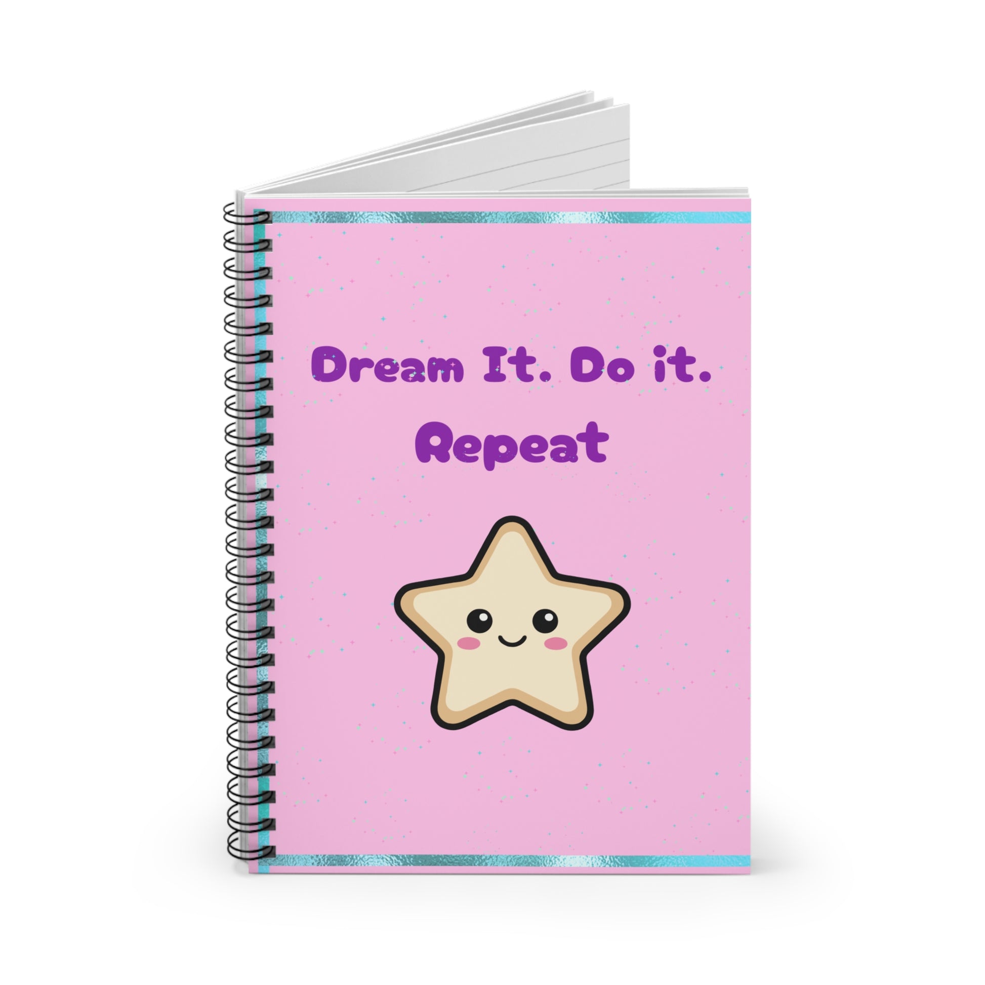 Notebook with a pink cover featuring a star illustration and text 'Dream It. Do it. Repeat' on a white background.