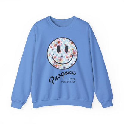 Blue sweatshirt with a smiley face design and text on a white background