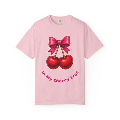 Pink t-shirt with cherry design and text on a white background