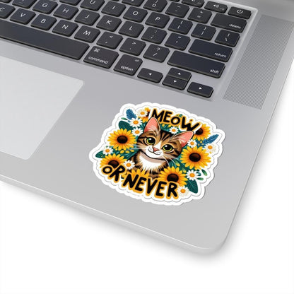 Laptop with a 'Meow or Never' cat and sunflower sticker on the palm rest area.