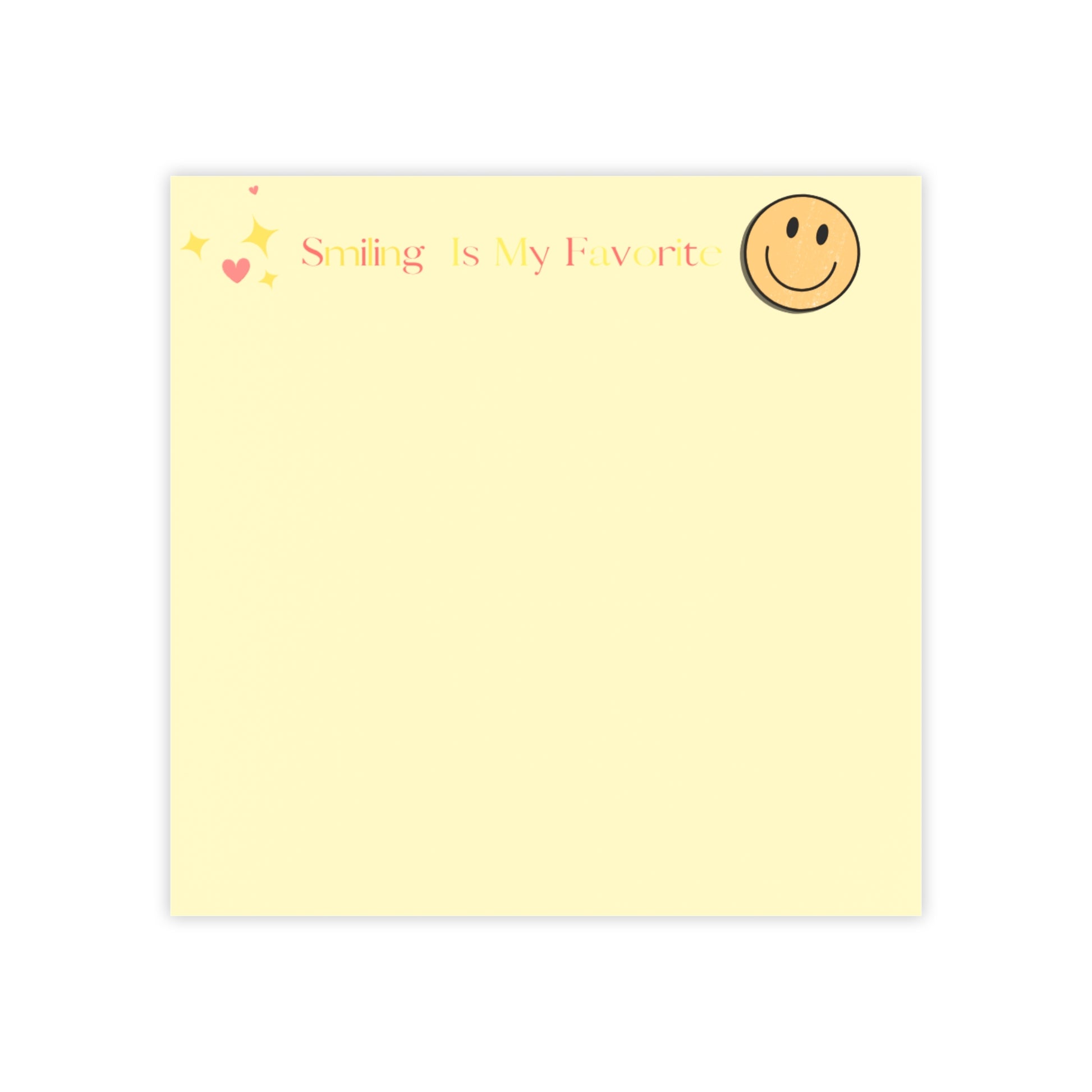 Yellow notepad with smiley face and text 'Smiling is my favorite' on a white background