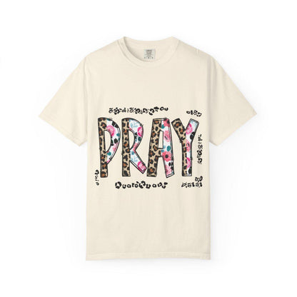 Beige t-shirt with 'PRAY' design featuring leopard print and floral patterns on a white background