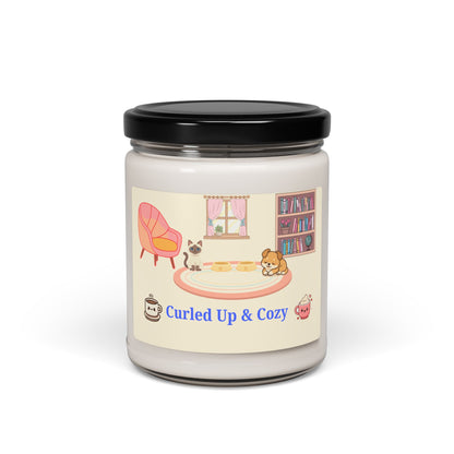 Candle jar with a 'Curled Up & Cozy' label featuring illustrations of a cozy room.