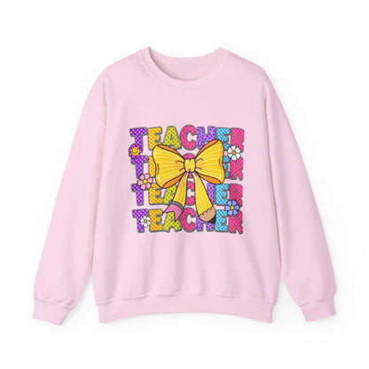 Pink sweatshirt with colorful 'Teacher' text and yellow bow design on a white background