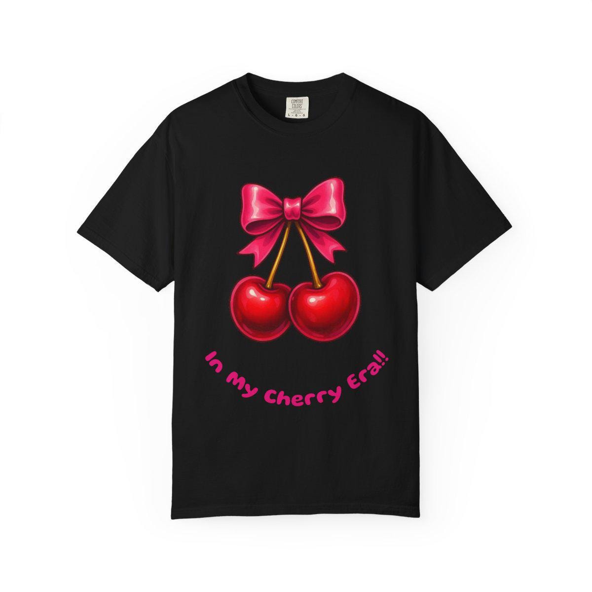 Black t-shirt with red cherries and a pink bow design on a white background